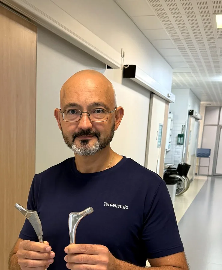 Rami Madanat holding hip implant components